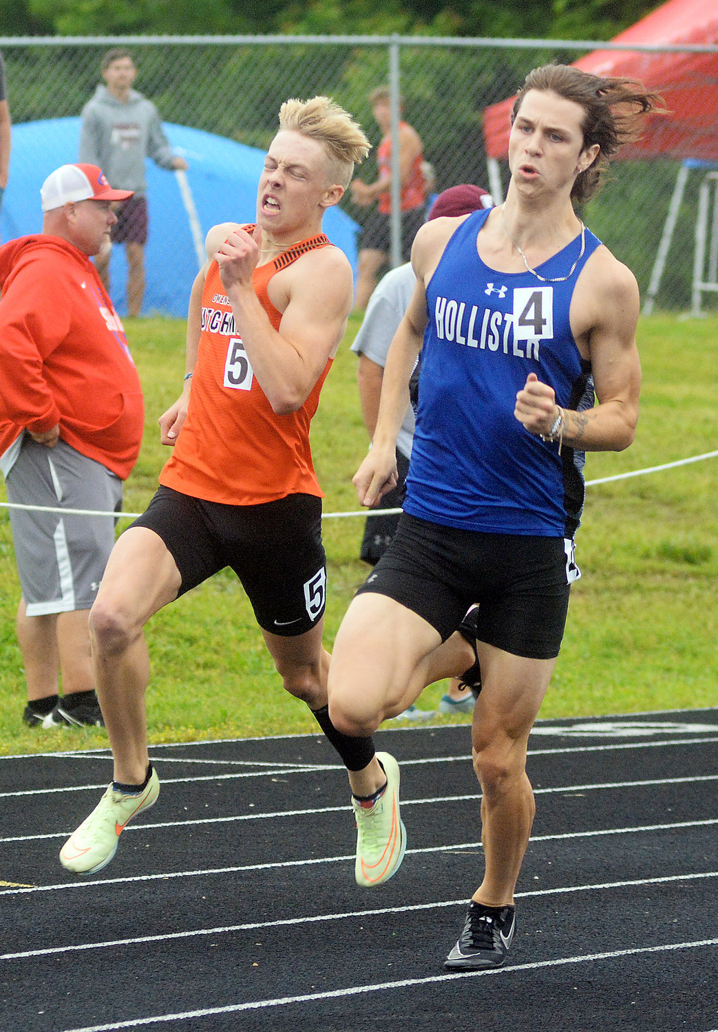 Jacob Breedlove (far left) turns the corner in the boys 200m dash with Hollister’s Tristen Parker racing right by his side. Breedlove won the race in 49.96 to advance to state.